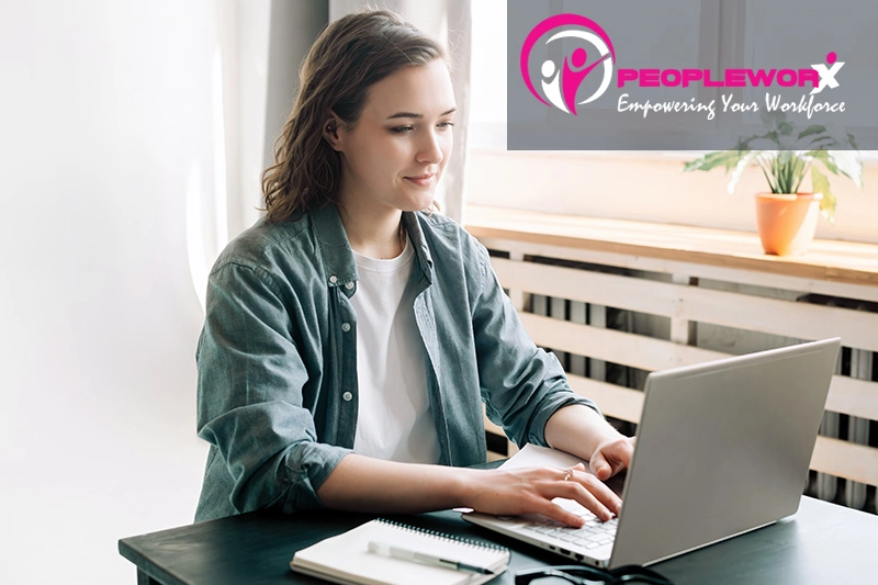 A business owner or HR manager reviewing paperwork with a contractor in a modern office setting