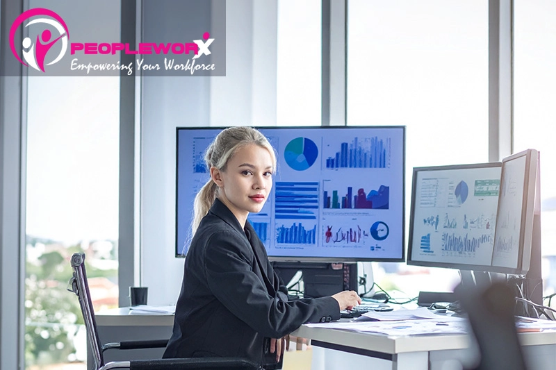 HR leader reviewing compliance data and workforce reports in 2026