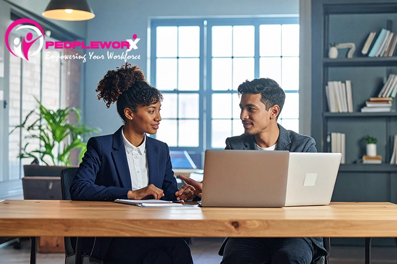 Manager and employee having a constructive feedback conversation in a calm workplace setting
