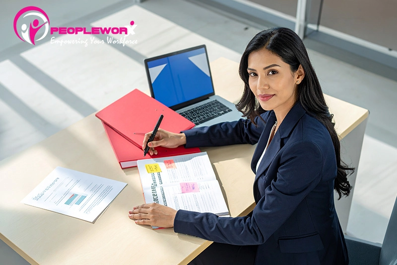 HR professional reviewing employee handbook policies for compliance updates