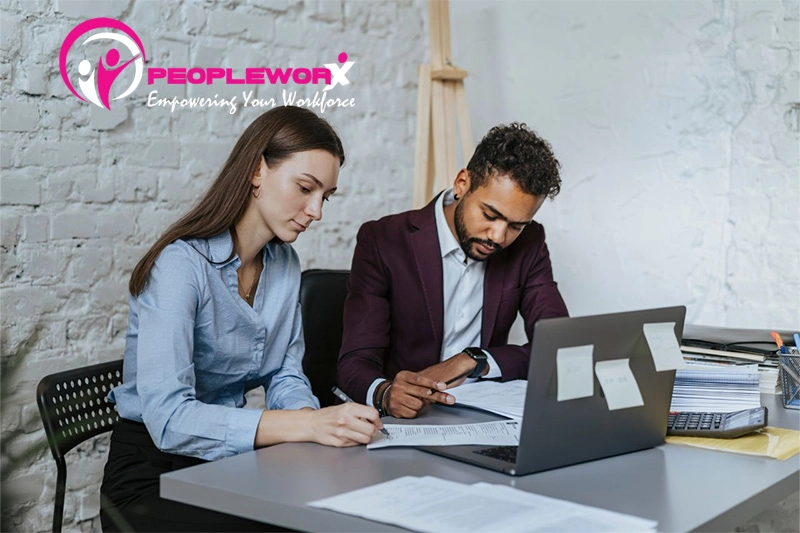 HR professional reviewing payroll records and exempt employee compliance documentation